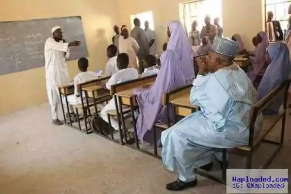 Photo: Borno Governor, Shettima sits with students during a class session to assess quality of teaching